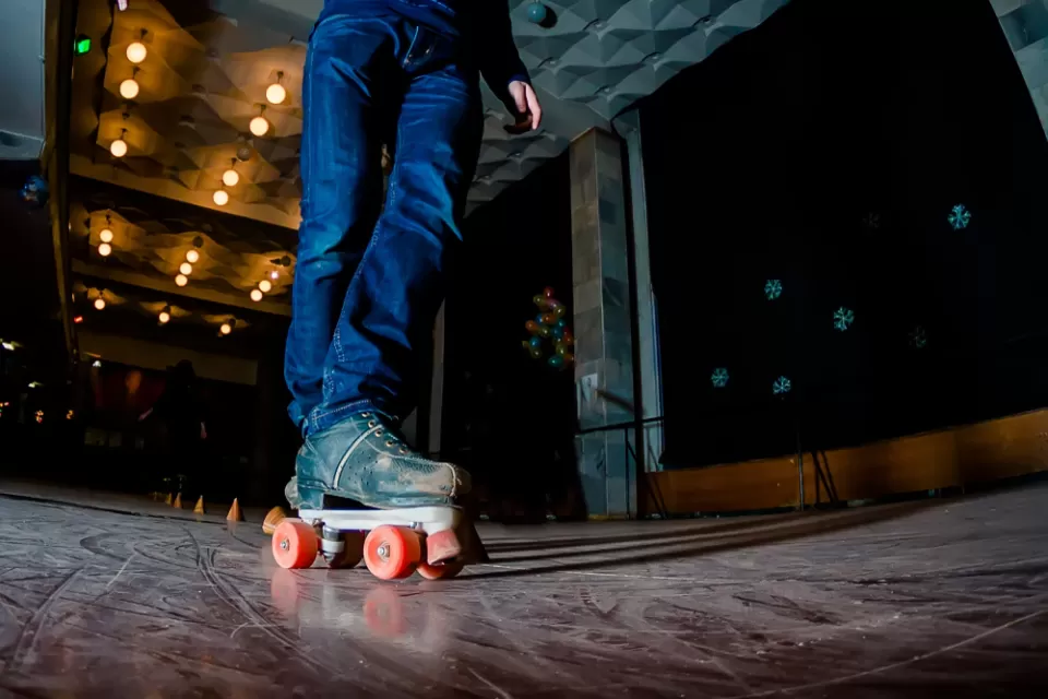 Close-up image of person skating on indoor roller rink